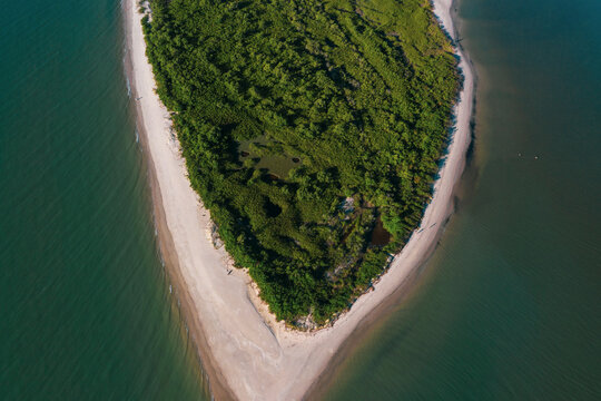 Brazil, Florianopolis. Panoramic aerial view of Daniela beach pontal peninsula and river showing sea, sand and trees.