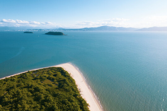 Brazil, Florianopolis. Panoramic aerial view of Daniela beach pontal peninsula and river showing sea, sand and trees.