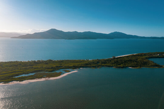 Brazil, Florianopolis. Panoramic aerial view of Daniela beach pontal peninsula and river showing sea, sand and trees.