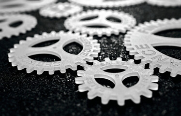 several gears with different inscription. topic of finance. in focus sales service