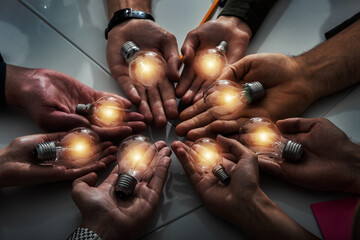 Teamwork and brainstorming concept with businessmen that share an idea with a lamp. Concept of...
