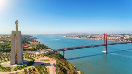 Aerial bridge on April 25th, Lisbon, Portugal. Statue of jesus christ lisbon. Sunny day. Close-up.