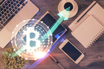 Double exposure of blockchain theme hologram over table with phone. Top view. Crypto technology...