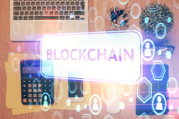 Double exposure of blockchain theme hologram over table with phone. Top view. Crypto technology...