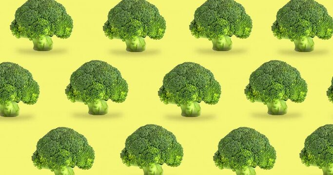 seamless pattern with animated broccoli on a yellow background. concept of healthy organic food. fresh raw green vegetables for vegan