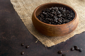 Dark Roast Coffee Beans in a Wooden Bowl on Burlap