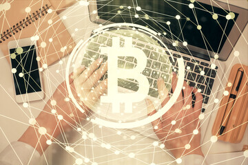 Double exposure of woman hands working on computer and blockchain theme hologram drawing. Top View. bitcoin cryptocurrency concept.