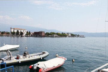 Lake Garda, in northern Italy surrounded by hills and villages with boats in the water