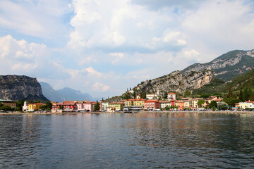 Fototapeta na wymiar Lake Garda, in northern Italy surrounded by hills and villages with boats in the water