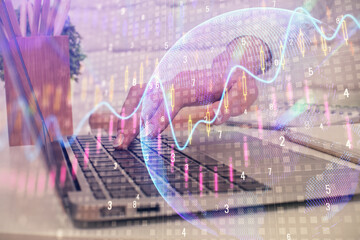 Multi exposure of woman hands typing on computer and forex chart hologram drawing. Stock market...