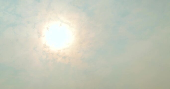 Sun Rises in the Sky Partially Hidden by Dense Clouds in Time Lapse