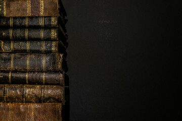 pile of old books on the left side of the image leaving space on the right side for Copyspace
