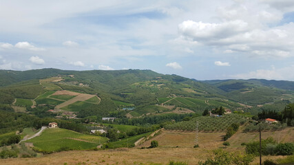 Fototapeta na wymiar Beautiful scenery looking across Tuscany featuring vineyards, buildings, farms