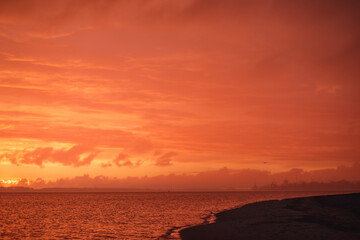 Crimson sunset the sky clears after a rain storm just long enough to show the deep red and purple clouds.