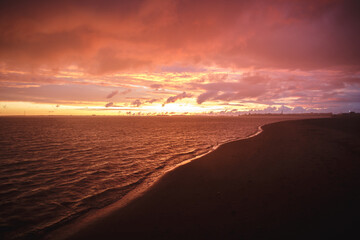 Crimson sunset the sky clears after a rain storm just long enough to show the deep red and purple clouds.