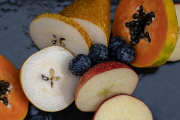 Fruits close up on black stone background