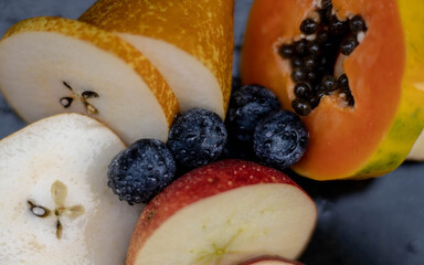 Fruits close up on black stone background