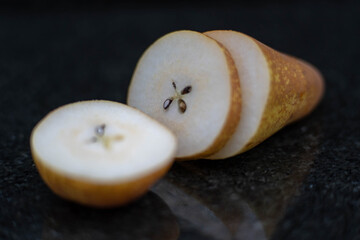 Pear close up on black stone background