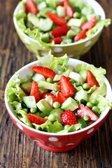 summer salad with strawberries, avocado,   green peas. copy space