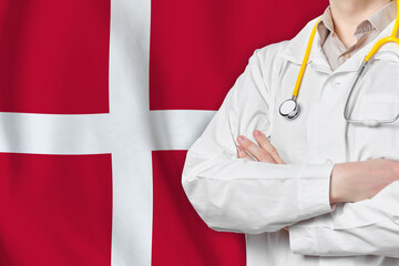 Kingdom of Denmark healthcare concept with doctor on flag background. Medical insurance, work or...