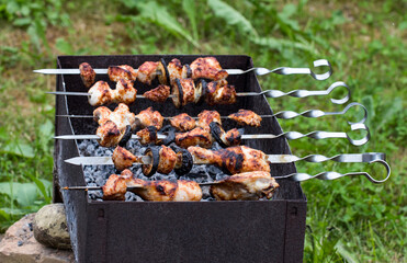 Skewers of chicken BBQ, frying chicken on skewers on the charcoal grill in the summer