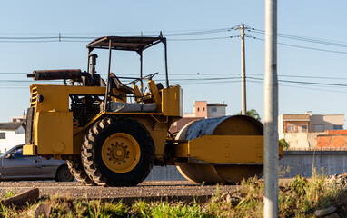 Obraz premium Yellow Smooth or Single-drum roller parked on a highway