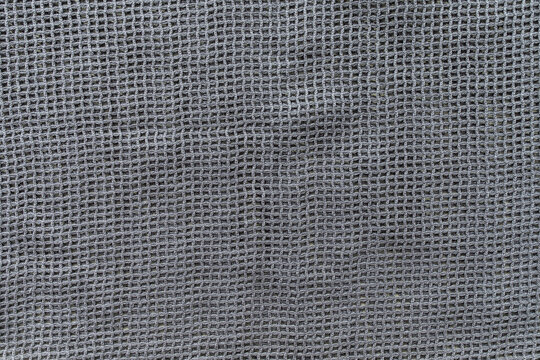 Gray eco shopping bag texture background. Plastic free and zero waste concept. Top view, close up