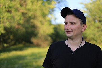 A young white guy or man in casual wear is enjoying the beauty of nature while being out of town,...