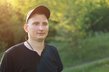 A young white guy or man in casual wear is enjoying the beauty of nature while being out of town,...