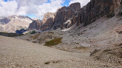 The rocky landscape of the Italian Dolomites in the summer. Rocks cast natural shadows. Cloudy sky