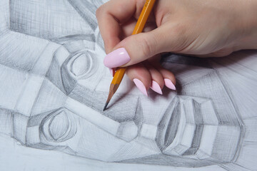 the artist's hand holds a pencil and eraser close-up.