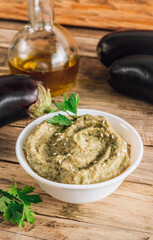 Traditional arabian eggplant dip baba ganoush on rustic wooden table