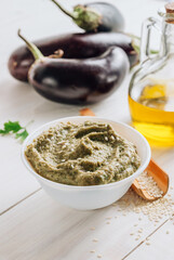 Traditional arabian eggplant dip baba ganoush on white wooden table