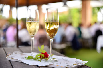 Two glasses of white wine ready for a wedding couple to toast.