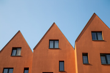 Orange brown apartment residential building under blue sky in Frankfurt, Germany