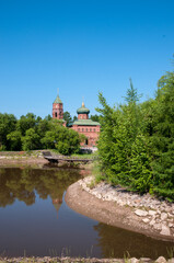 Fototapeta na wymiar Russian village, summer landscape lake and old Orthodox Church