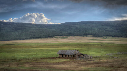 Abandoned farmstead structures on the Great  Plains with Dramatic Skies Overhead