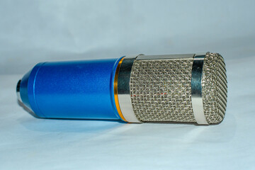 Blue and silver colour voice microphone on white background.