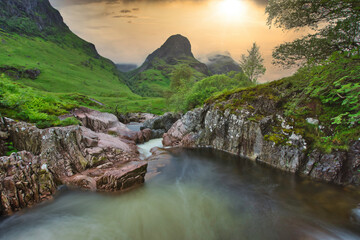 River Coe,  at sunset with the three sisters in view, Glencoe, Highlands, Scotland. - obrazy, fototapety, plakaty