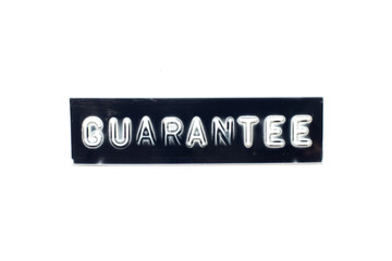 Embossed letter in word guarantee on black banner with white background