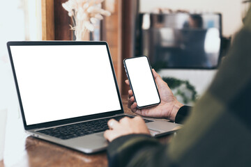 computer,cell phone mockup image.hand woman work using laptop texting mobile.blank screen with white background for advertising,contact business search information on desk in cafe.marketing,design