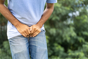 young man with hands holding his crotch, Urinary Tract Infection concept Painful Bladder Syndrome and interstitial cystitis - obrazy, fototapety, plakaty