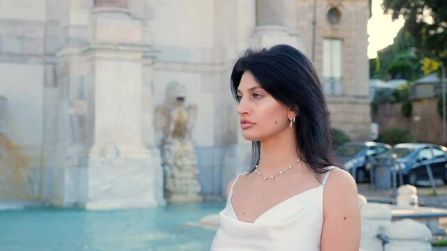 proud confident woman walking in the city - janiculum fountain in background