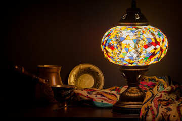 Table lamp of Turkish origin on wooden table and Turkish decoration