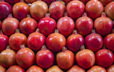 Red pomegranate arranged artistically at a Fruit stall in Mysore market place in Karnataka /India.