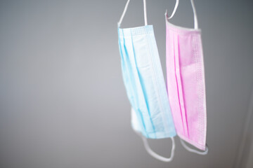 Pink and blue surgical mask on blur background.
