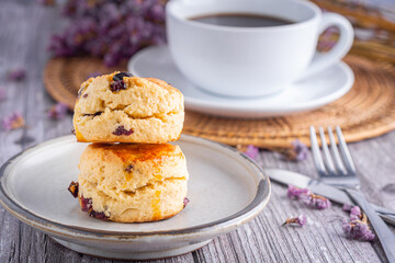 Fototapeta na wymiar Traditional British scones with a white coffee cup cup and blurred background