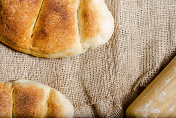 Bread prepared with a crust made in the oven with your own hands on a wooden table. flour and bakery artifacts