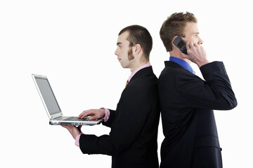 Businessmen talking on the cell phone and using laptop