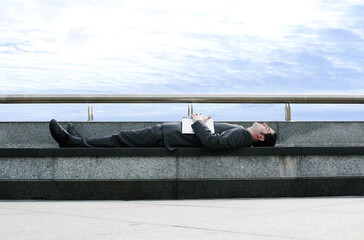 Businessman sleeping on the bench